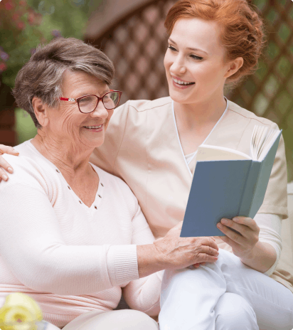 Home Care Service Patient and Provider reading a book